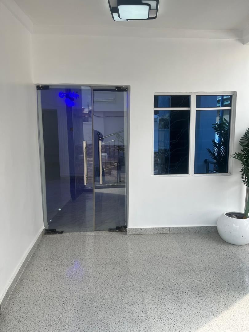 Govaxoni Suites glass entrance at night