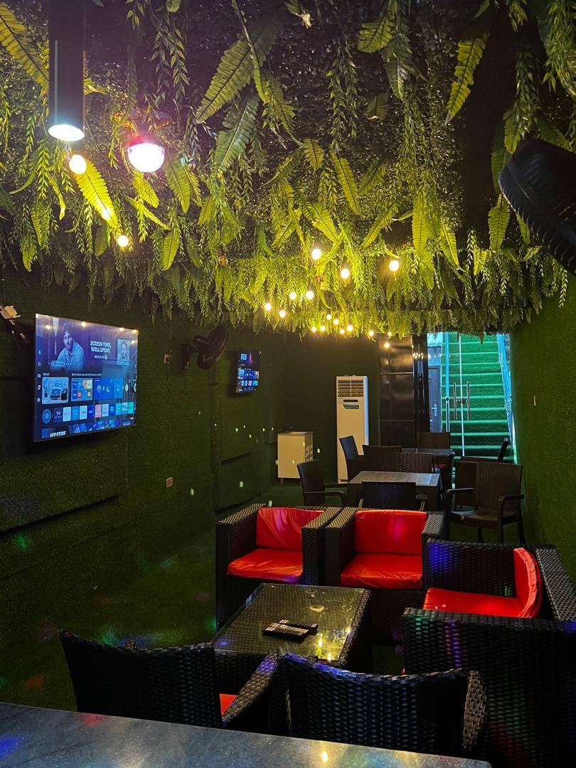 Guest lounge with greenery and TVs